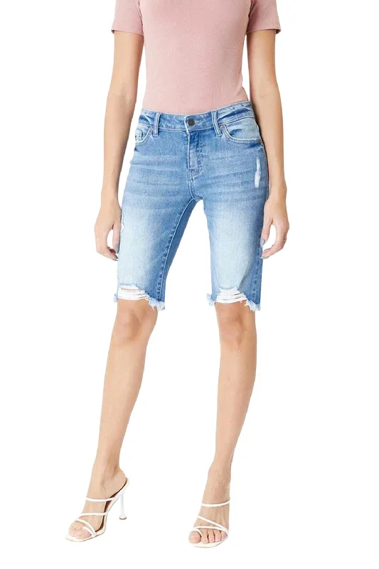 Slightly Flared Design Mid Rise Distressed Hem Bermuda Short In Medium Wash